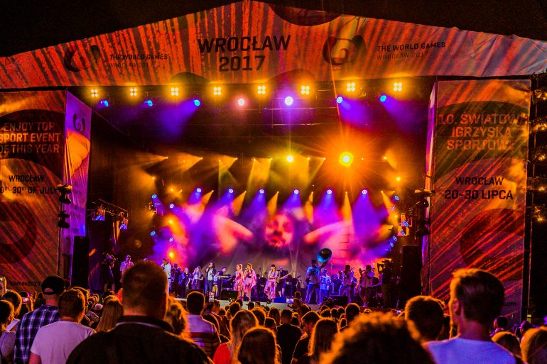 Photo of band performing in front of crowd at night in Wroclaw 2017