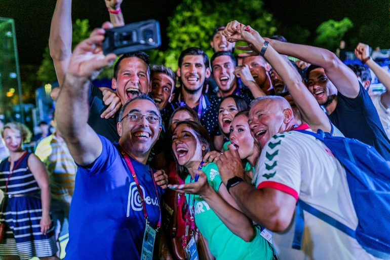 Photo of several people getting a group selfie