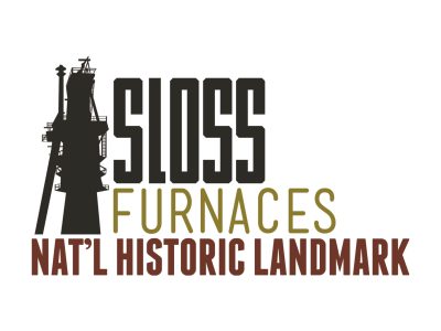 Furnace next to text of Sloss Furnaces National Historic Landmark