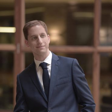 Photo of man smiling off camera