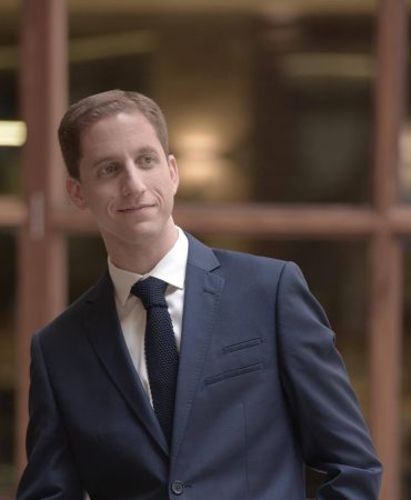 Photo of man smiling off camera